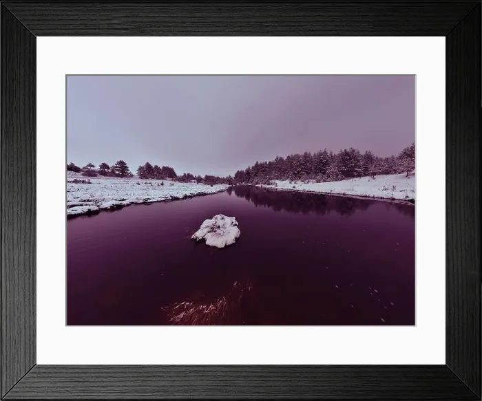Framed Print : An aerial view of a frozen river flowing through snow-covered forests on a cloudy sunset sky background Framed Print : An aerial view of a frozen river flowing through snow-covered forests on a cloudy sunset sky background