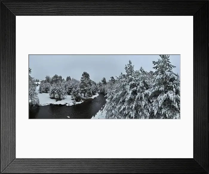 Framed Print : An aerial view of a frozen river flowing through snow-covered forests on a cloudy sunset sky background Framed Print : An aerial view of a frozen river flowing through snow-covered forests on a cloudy sunset sky background