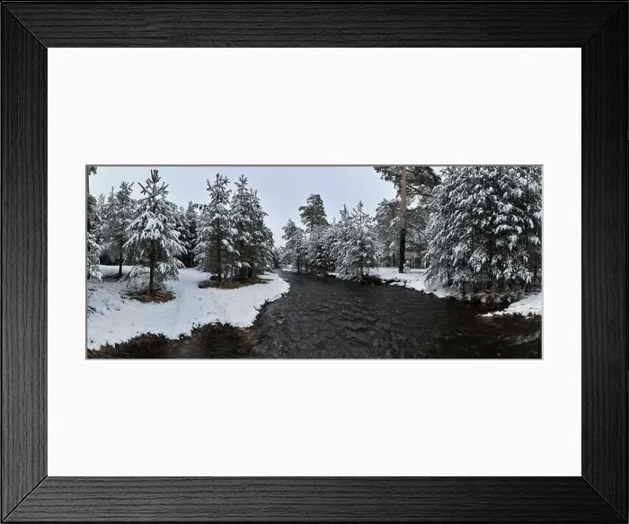 Framed Print : An aerial view of a frozen river flowing through snow-covered forests on a cloudy sunset sky background Framed Print : An aerial view of a frozen river flowing through snow-covered forests on a cloudy sunset sky background