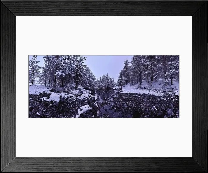 Framed Print : An aerial view of a frozen river flowing through snow-covered forests on a cloudy sunset sky background Framed Print : An aerial view of a frozen river flowing through snow-covered forests on a cloudy sunset sky background