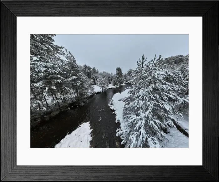 Framed Print : An aerial view of a frozen river flowing through snow-covered forests on a cloudy sunset sky background Framed Print : An aerial view of a frozen river flowing through snow-covered forests on a cloudy sunset sky background