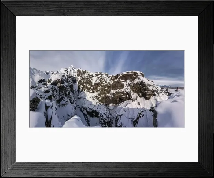Framed Print : Tourist in outerwear standing near snowy mountain range covered with snow against cloudless blue sky in winter in Framed Print : Tourist in outerwear standing near snowy mountain range covered with snow against cloudless blue sky in winter in