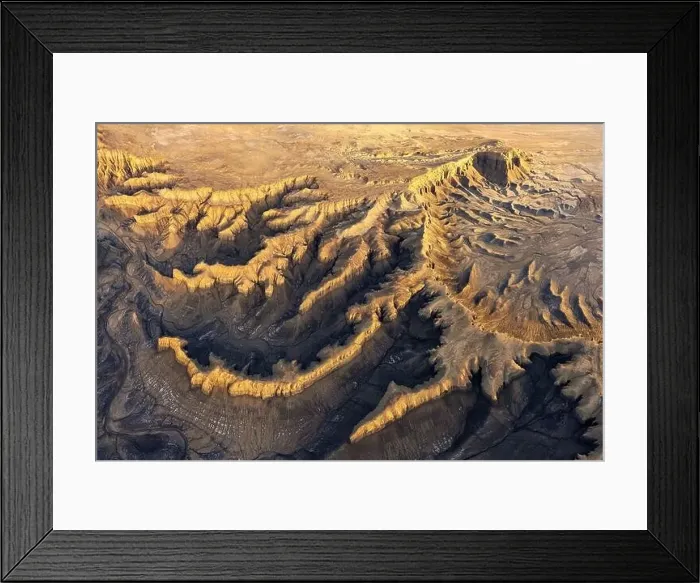 Framed Print : From above drone view of picturesque scenery with rough rocky formations and dry land in North Caineville Mesa Framed Print : From above drone view of picturesque scenery with rough rocky formations and dry land in North Caineville Mesa