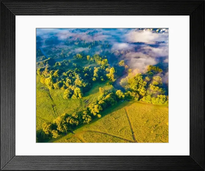 Framed Print : Straight down view from flying drone of small river in the foggy forest