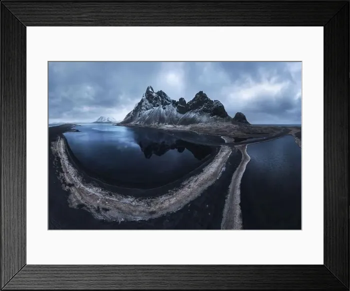 Framed Print : From above drone view of rocky mountains covered with snow located near waving seawater on south coast of Iceland Framed Print : From above drone view of rocky mountains covered with snow located near waving seawater on south coast of Iceland
