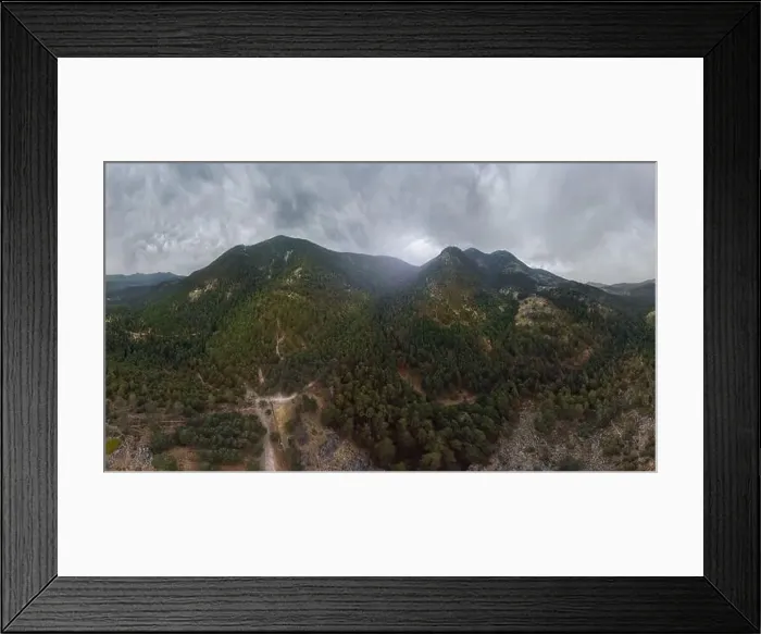 Framed Print : Drone aerial top view of lush green trees growing in woodland against cloudy mountain in countryside Framed Print : Drone aerial top view of lush green trees growing in woodland against cloudy mountain in countryside