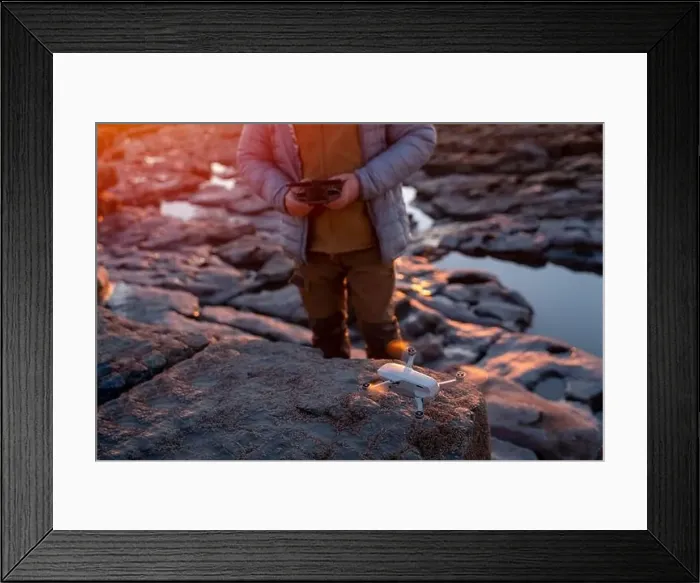 Framed Print : Bearded man using a drone with remote controller making photos and videos, having fun with new technology trends Framed Print : Bearded man using a drone with remote controller making photos and videos, having fun with new technology trends