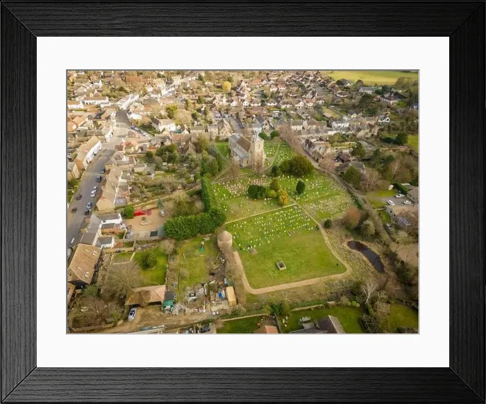 Framed Print : Aerial view of a typical English village with the old Church seen at the centre of the village with its large cemetery Framed Print : Aerial view of a typical English village with the old Church seen at the centre of the village with its large cemetery