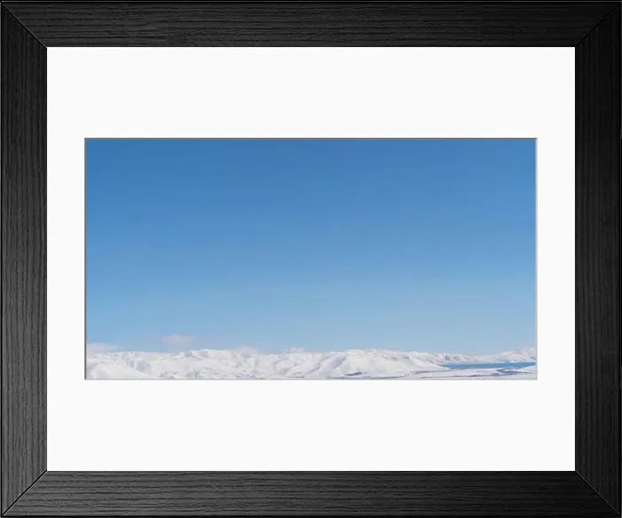 Framed Print : Aerial view snow covered mountains. Snowy mountain ridge on winter sunrise. Stunning mountains range covered with snow Framed Print : Aerial view snow covered mountains. Snowy mountain ridge on winter sunrise. Stunning mountains range covered with snow