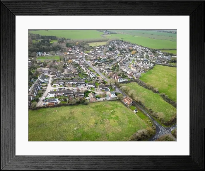 Framed Print : Aerial view of a typical English village showing housing development expansion over the years Framed Print : Aerial view of a typical English village showing housing development expansion over the years
