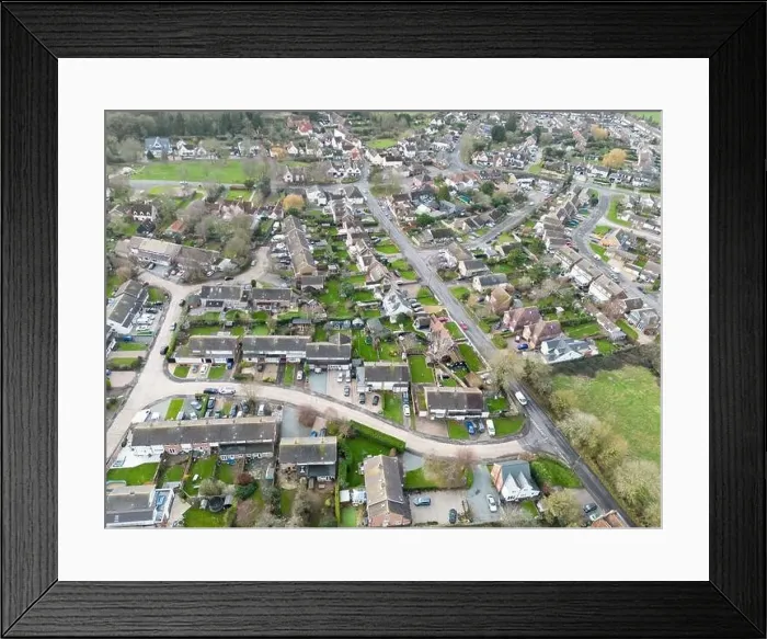 Framed Print : Aerial view of a typical English village showing housing development expansion over the years Framed Print : Aerial view of a typical English village showing housing development expansion over the years