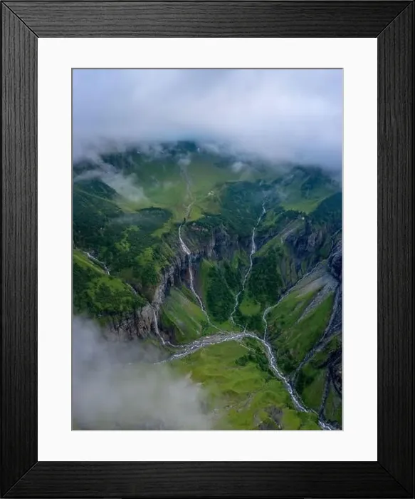 Framed Print : Aerial shot of several large waterfalls cascading down a steep cliff Framed Print : Aerial shot of several large waterfalls cascading down a steep cliff