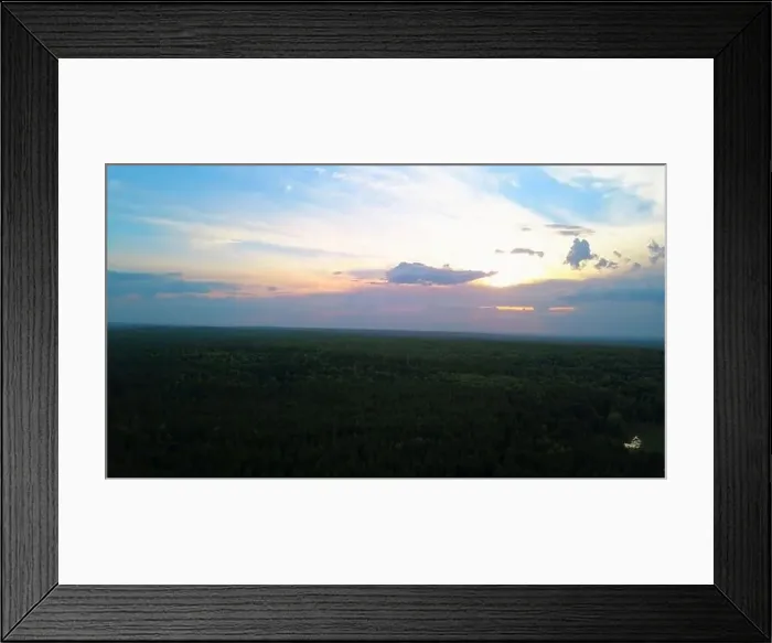 Framed Print : Top view of forest and sunset rays of sun in clouds Framed Print : Top view of forest and sunset rays of sun in clouds