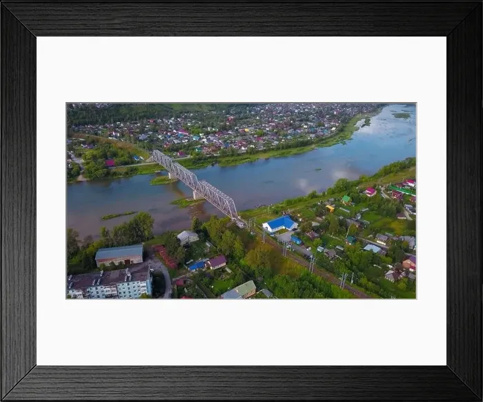 Framed Print : Summer aerial view. Clip. A large dirty river flowing around the forest and small residential buildings are visible Framed Print : Summer aerial view. Clip. A large dirty river flowing around the forest and small residential buildings are visible