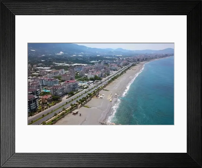 Framed Print : View of the ocean coastline next to which cars drive Framed Print : View of the ocean coastline next to which cars drive