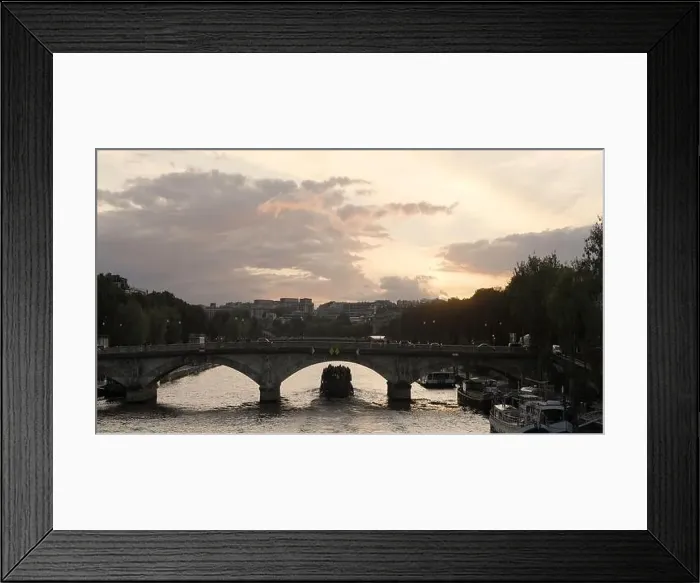 Framed Print : European landscapes. Action. A rainy city with busy traffic and cyclists and bridges over the river Framed Print : European landscapes. Action. A rainy city with busy traffic and cyclists and bridges over the river