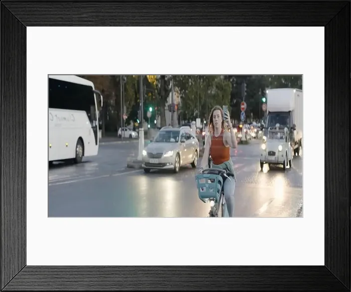 Framed Print : European landscapes. Action. A rainy city with busy traffic and cyclists and bridges over the river Framed Print : European landscapes. Action. A rainy city with busy traffic and cyclists and bridges over the river