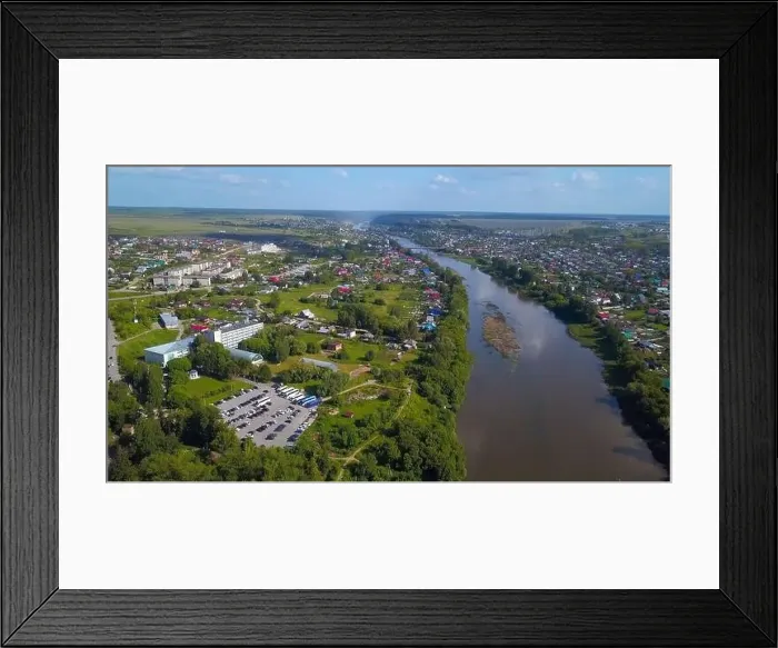 Framed Print : Summer aerial view. Clip. A large dirty river flowing around the forest and small residential buildings are visible Framed Print : Summer aerial view. Clip. A large dirty river flowing around the forest and small residential buildings are visible