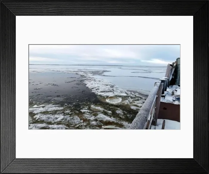 Framed Print : Aerial view of a barge on a winter river with ice. Clip. Concept of water transportation of goods Framed Print : Aerial view of a barge on a winter river with ice. Clip. Concept of water transportation of goods