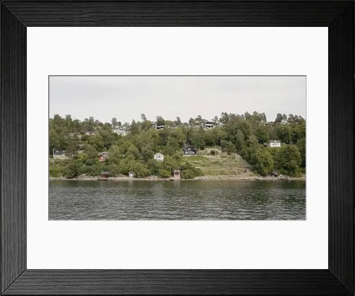 Framed Print : Natural landscape with rippling river and houses by the coast Framed Print : Natural landscape with rippling river and houses by the coast