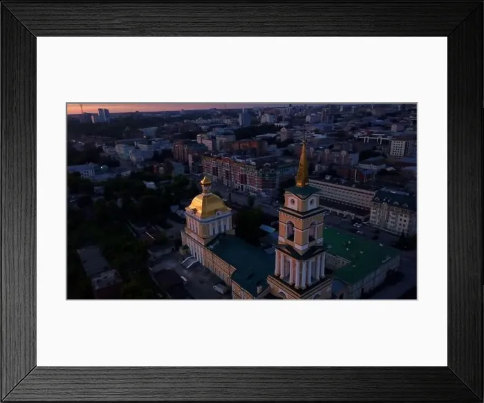 Framed Print : Aerial view of the sunset sky above the wide river. Clip. Green town located along the river