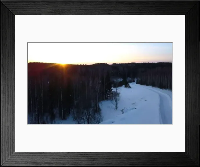 Framed Print : Aerial view of a snowmobile driving along pine tree forest. Clip. Sunset sky and rural snow covered road Framed Print : Aerial view of a snowmobile driving along pine tree forest. Clip. Sunset sky and rural snow covered road