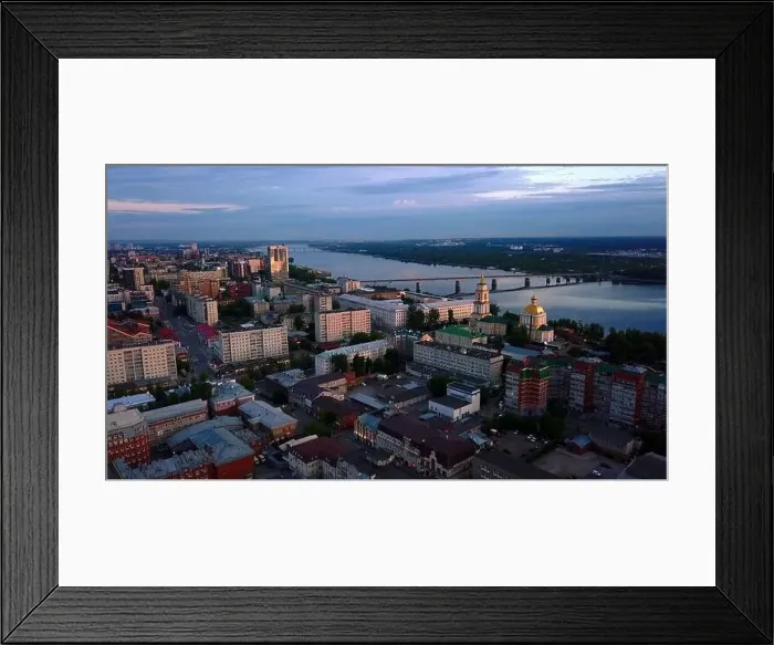 Framed Print : Aerial view of the sunset sky above the wide river. Clip. Green town located along the river Framed Print : Aerial view of the sunset sky above the wide river. Clip. Green town located along the river