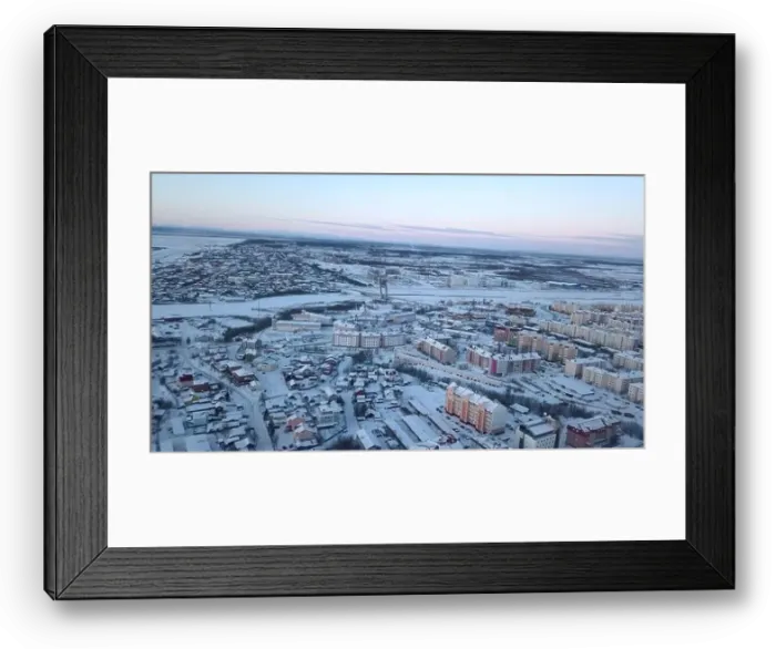 Framed Print : Aerial view of a big city with building roofs covered by snow. Clip. Flying above frozen city and a river Framed Print : Aerial view of a big city with building roofs covered by snow. Clip. Flying above frozen city and a river