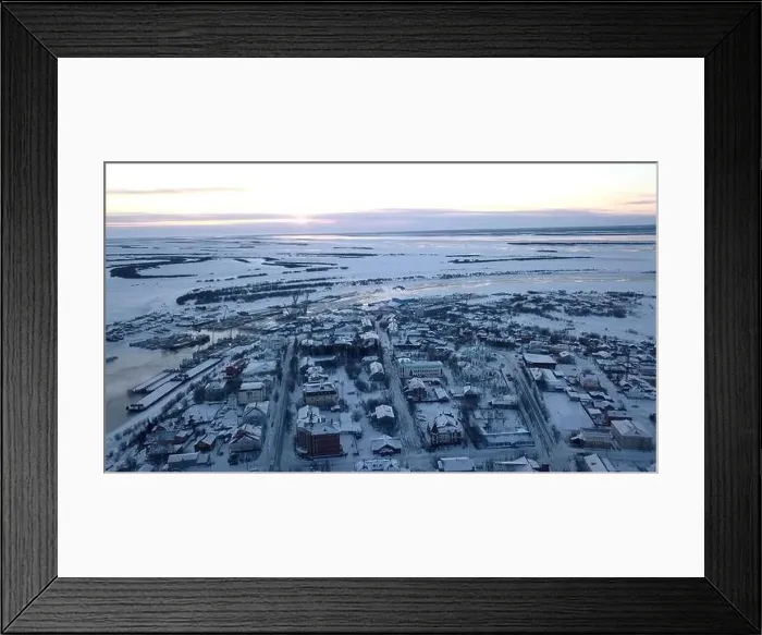 Framed Print : Aerial view of a big city with building roofs covered by snow. Clip. Flying above frozen city and a river Framed Print : Aerial view of a big city with building roofs covered by snow. Clip. Flying above frozen city and a river