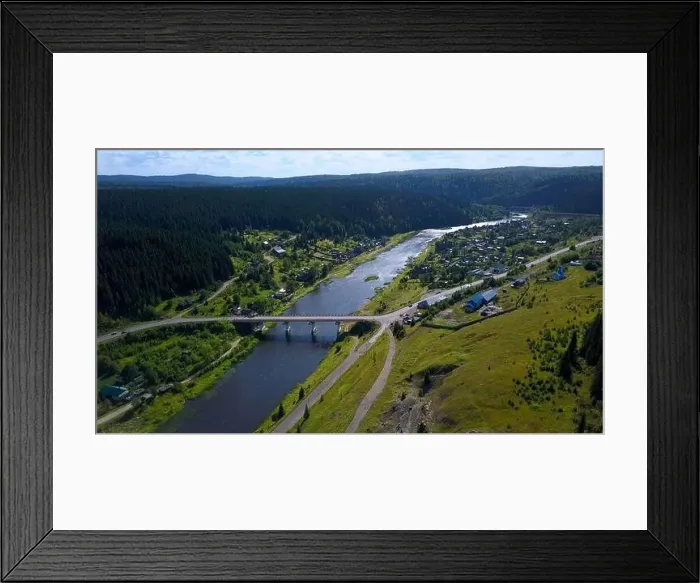 Framed Print : Aerial view of a picturesque valley with a village. Clip. Wide river crossed by a bridge and forested hills Framed Print : Aerial view of a picturesque valley with a village. Clip. Wide river crossed by a bridge and forested hills
