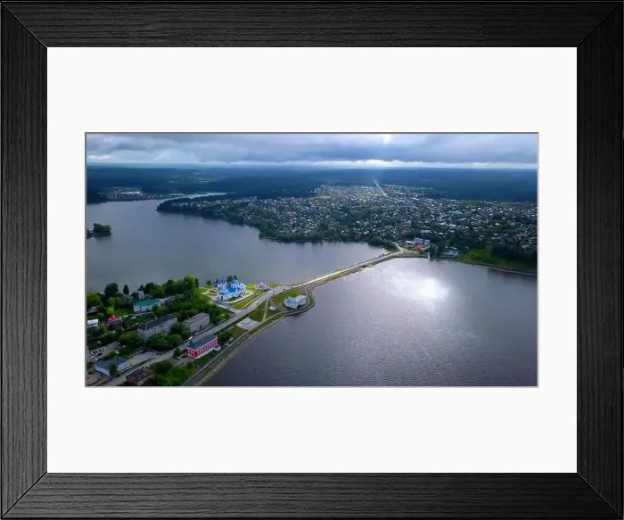 Framed Print : Aerial view of a picturesque valley with a village. Clip. Wide river crossed by a bridge and forested hills Framed Print : Aerial view of a picturesque valley with a village. Clip. Wide river crossed by a bridge and forested hills