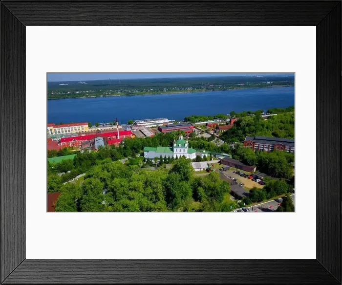 Framed Print : Aerial view of a village located by the river shore. Clip. Flying above summer green nature and buildings Framed Print : Aerial view of a village located by the river shore. Clip. Flying above summer green nature and buildings
