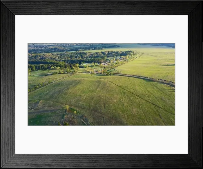Framed Print : Aerial view of a rural countryside road stretching along farm fields and forest Framed Print : Aerial view of a rural countryside road stretching along farm fields and forest