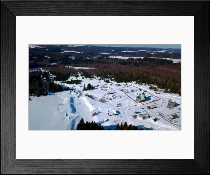 Framed Print : Aerial view of lonely houses located in the countryside near dense forest. Clip. Aerial view of a winter sunny day