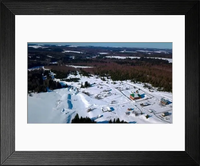 Framed Print : Aerial view of lonely houses located in the countryside near dense forest. Clip. Aerial view of a winter sunny day