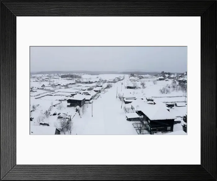 Framed Print : Aerial view of snow covered roofs of wooden houses. Clip. Small winter village on a heavy cloudy sky background Framed Print : Aerial view of snow covered roofs of wooden houses. Clip. Small winter village on a heavy cloudy sky background