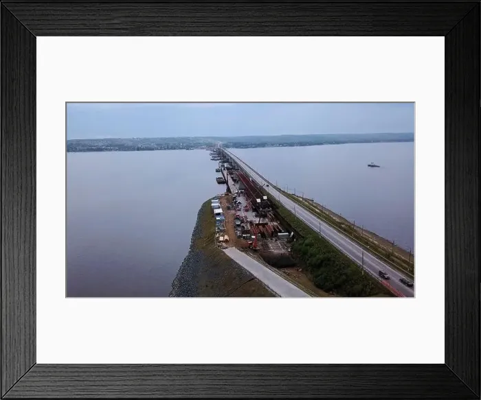 Framed Print : Aerial view of a wide river or lake crossed by the long narrow bridge with moving cars Framed Print : Aerial view of a wide river or lake crossed by the long narrow bridge with moving cars
