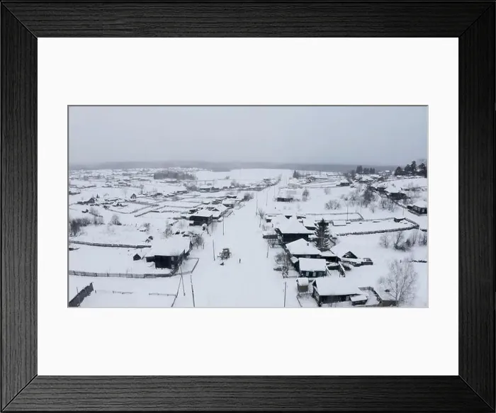Framed Print : Aerial view of snow covered roofs of wooden houses. Clip. Small winter village on a heavy cloudy sky background Framed Print : Aerial view of snow covered roofs of wooden houses. Clip. Small winter village on a heavy cloudy sky background