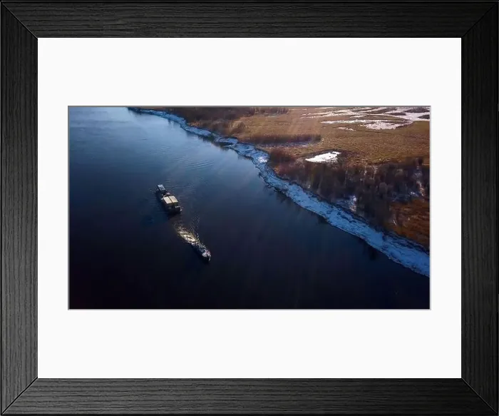 Framed Print : Industrial background with a barge and a river with snowy shore Framed Print : Industrial background with a barge and a river with snowy shore