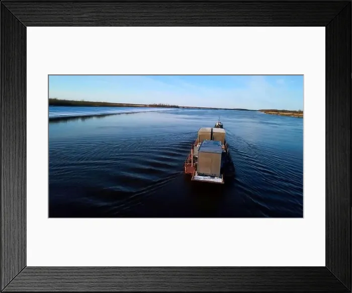 Framed Print : Industrial background with a barge and a river with snowy shore Framed Print : Industrial background with a barge and a river with snowy shore
