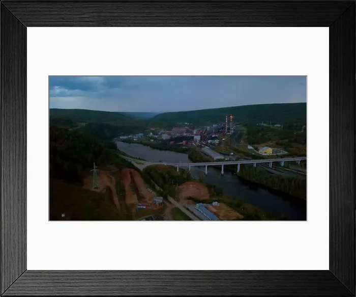 Framed Print : Flying above the river through small town and mountain landscape. Clip. Bridge across the wide river leading to the town Framed Print : Flying above the river through small town and mountain landscape. Clip. Bridge across the wide river leading to the town