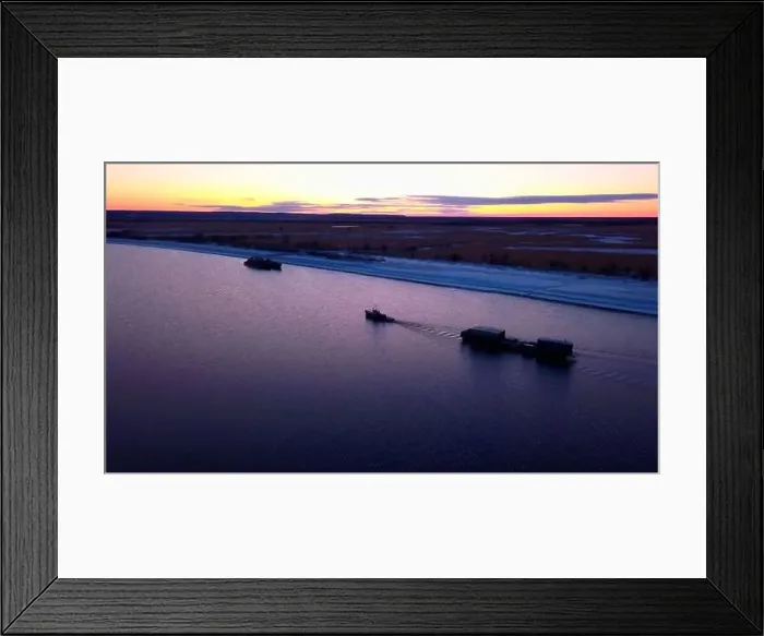 Framed Print : Evening scenery with sunset beautiful sky and a lonely cargo ship transporting containers with goods Framed Print : Evening scenery with sunset beautiful sky and a lonely cargo ship transporting containers with goods