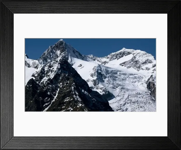 Framed Print : Aerial view of epic winter snow covered mountains on a blue background. Creative. Sharp slopes and cliffs Framed Print : Aerial view of epic winter snow covered mountains on a blue background. Creative. Sharp slopes and cliffs