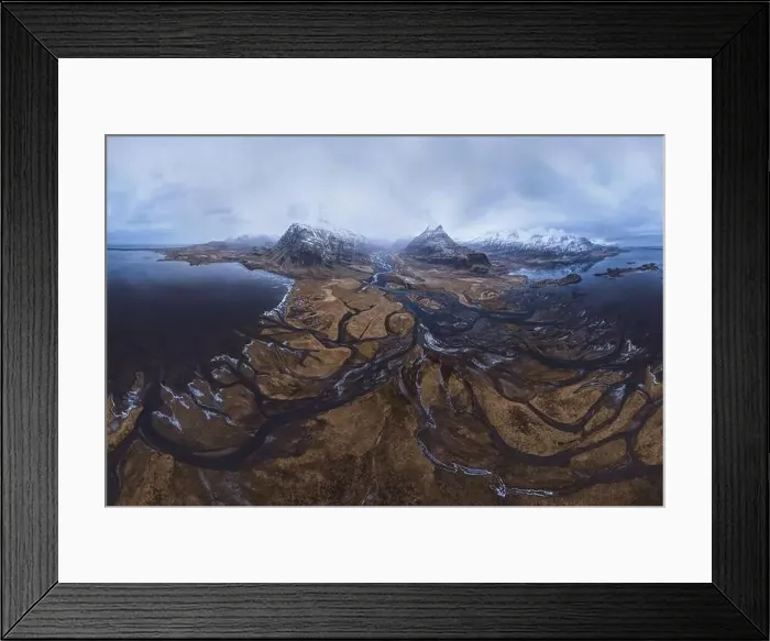 Framed Print : From above aerial view of river estuary and ocean coast near mountain peaks covered with snow in winter time in Iceland Framed Print : From above aerial view of river estuary and ocean coast near mountain peaks covered with snow in winter time in Iceland