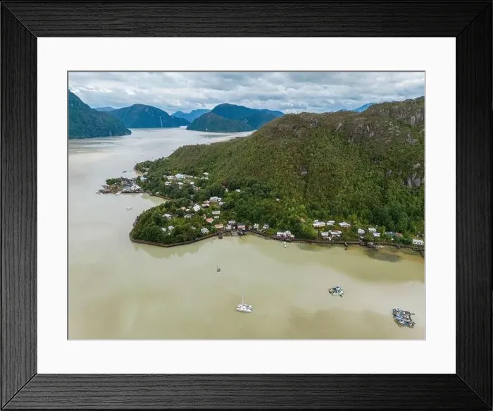 Framed Print : Drone view of Caleta Tortel with its small cabins - Discovering the beautiful village while traveling the Carretera Framed Print : Drone view of Caleta Tortel with its small cabins - Discovering the beautiful village while traveling the Carretera
