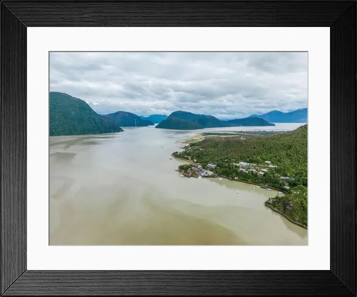 Framed Print : Drone view of Caleta Tortel with its small cabins - Discovering the beautiful village while traveling the Carretera