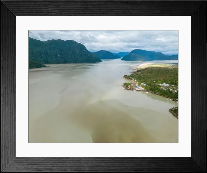 Framed Print : Drone view of Caleta Tortel with its small cabins - Discovering the beautiful village while traveling the Carretera