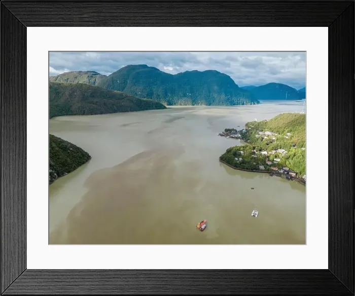 Framed Print : Drone view of Caleta Tortel with its small cabins - Discovering the beautiful village while traveling the Carretera Framed Print : Drone view of Caleta Tortel with its small cabins - Discovering the beautiful village while traveling the Carretera