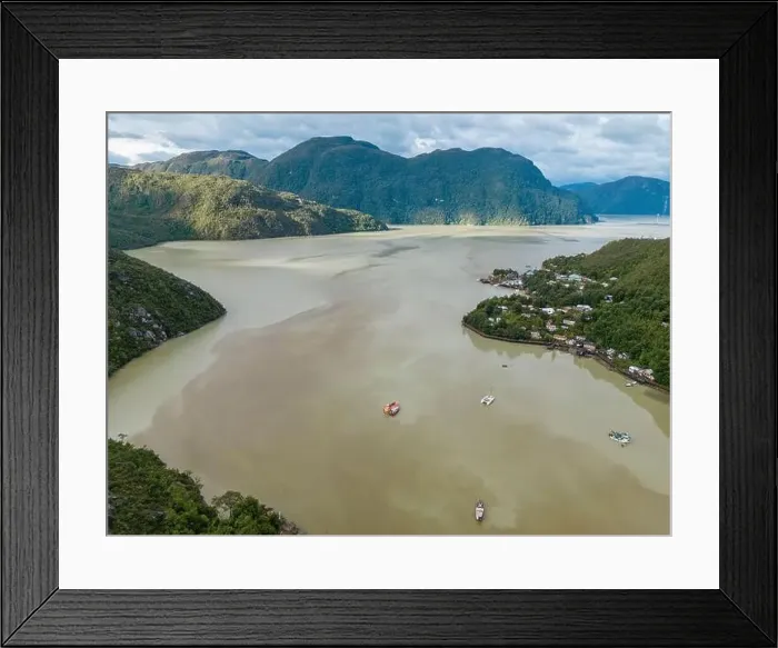Framed Print : Drone view of Caleta Tortel with its small cabins - Discovering the beautiful village while traveling the Carretera Framed Print : Drone view of Caleta Tortel with its small cabins - Discovering the beautiful village while traveling the Carretera