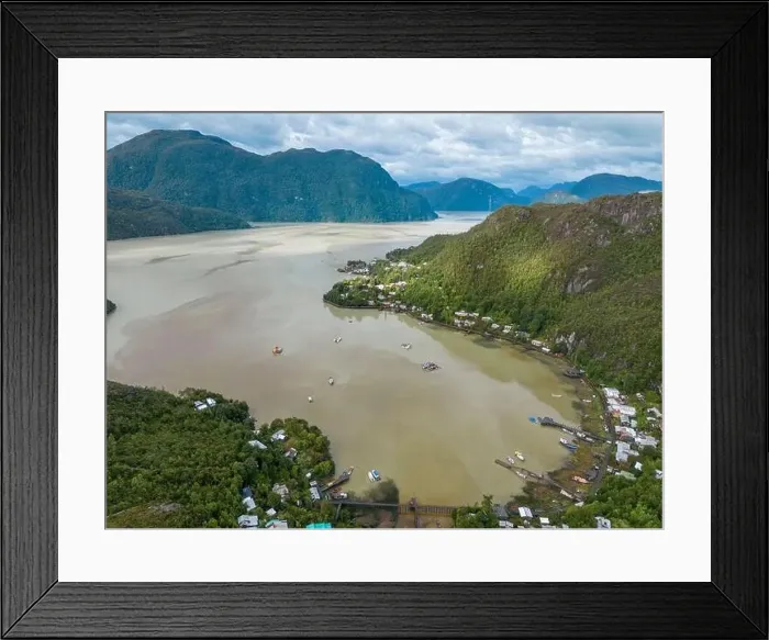 Framed Print : Drone view of Caleta Tortel with its small cabins - Discovering the beautiful village while traveling the Carretera Framed Print : Drone view of Caleta Tortel with its small cabins - Discovering the beautiful village while traveling the Carretera
